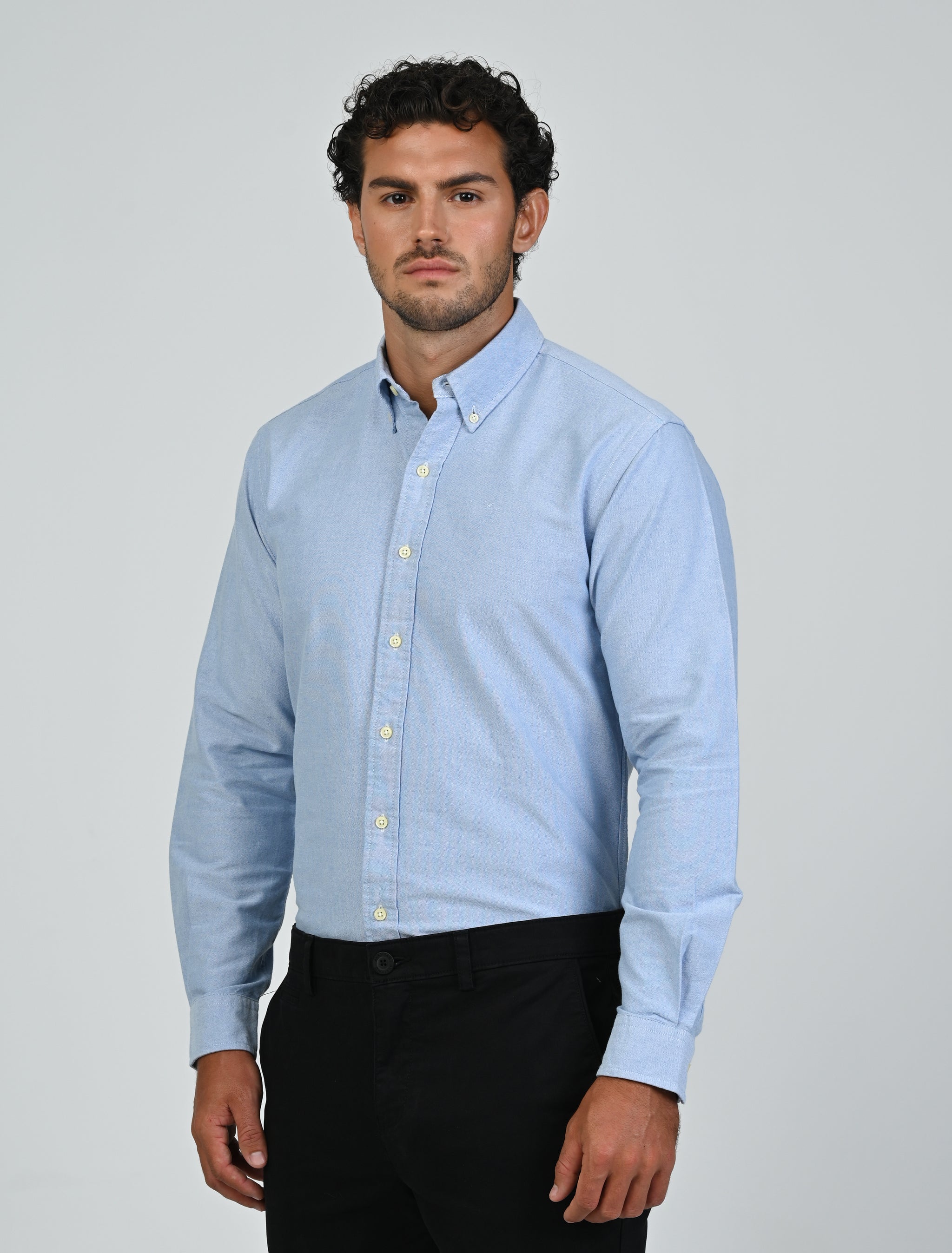 Three-quarter view of the Marshall Menswear Harrington Oxford Shirt in tropical blue with a classic button-down collar and Oxford cotton fabric.