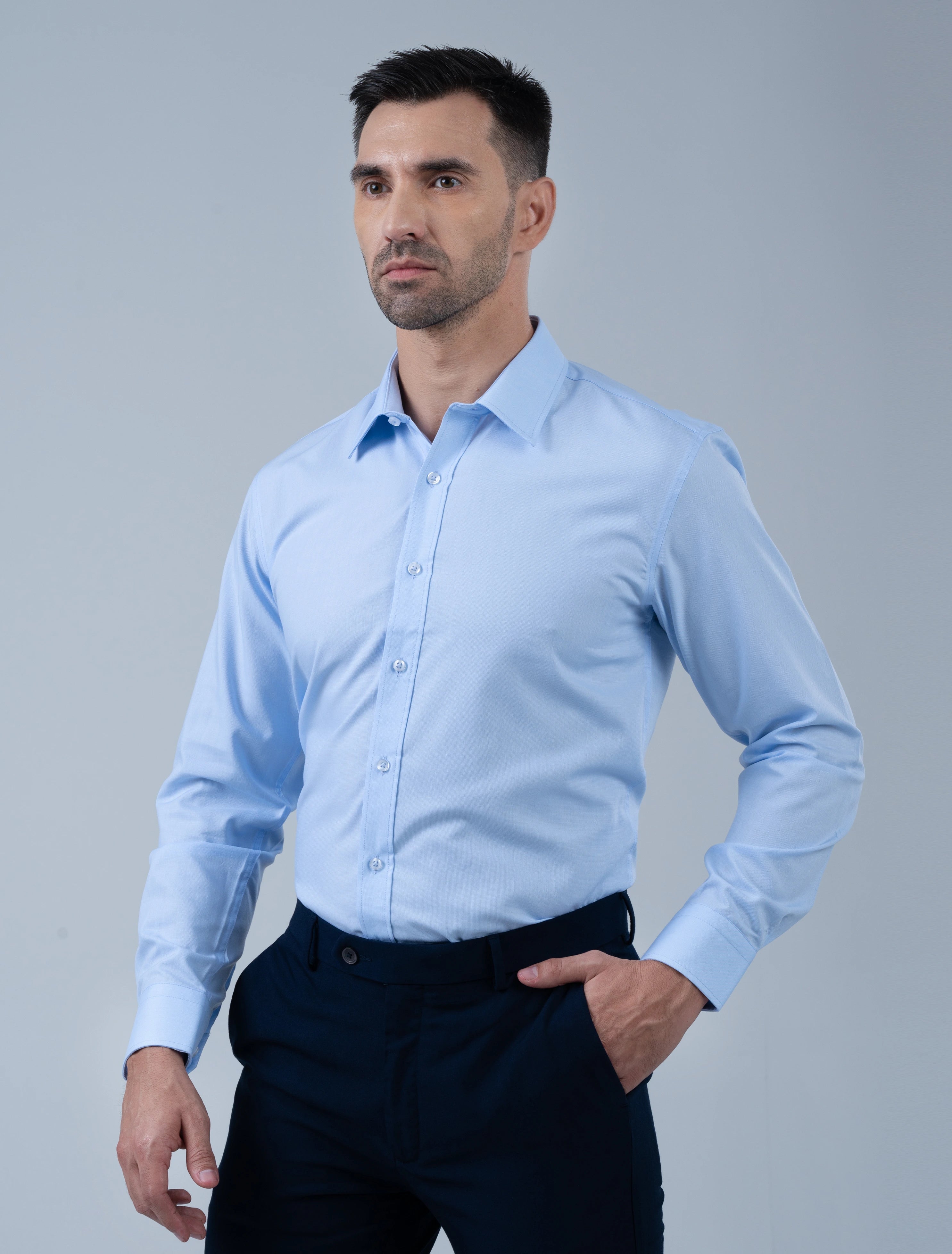 Model wearing the Marshall Menswear Kingsley premium men's formal shirt in light blue, showcasing a tailored silhouette, crisp collar and refined business attire.