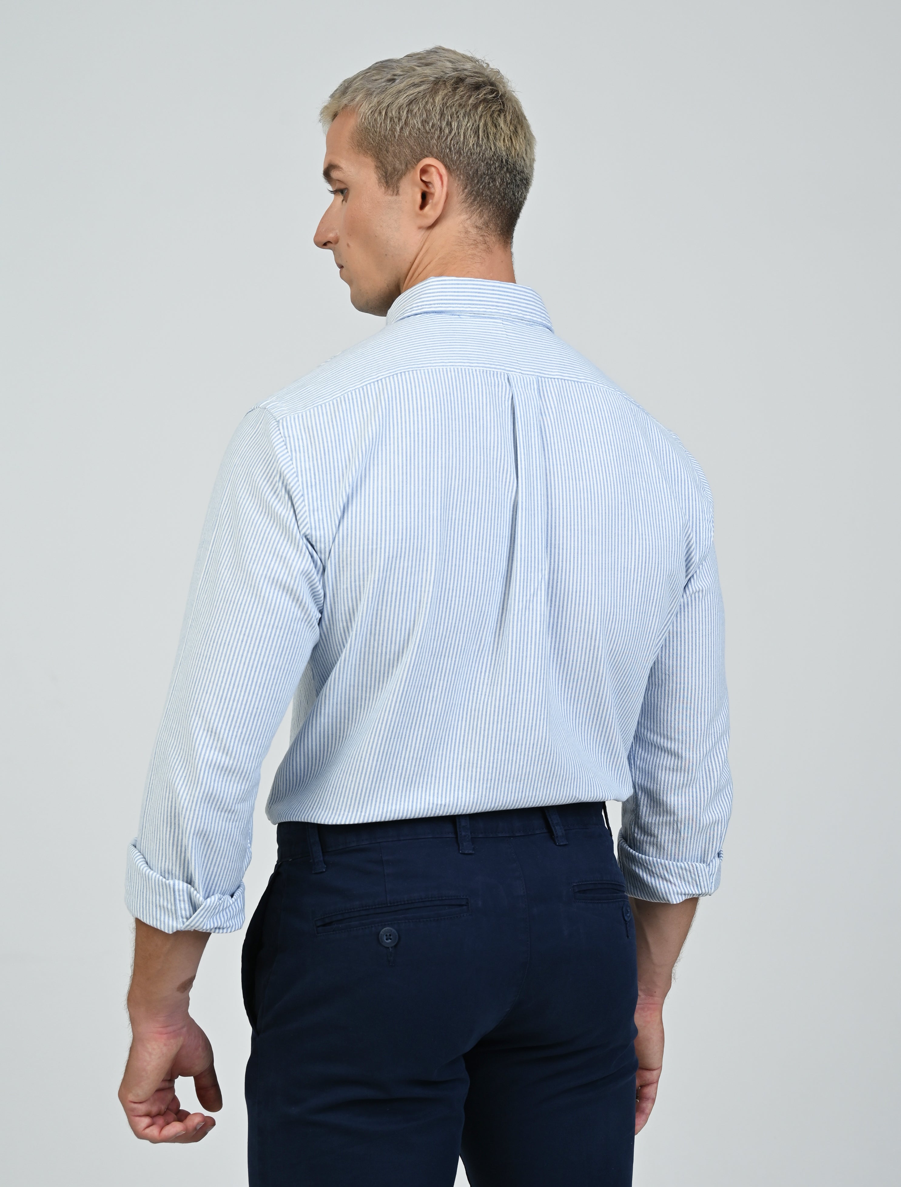 Model wearing the Marshall Menswear Marlowe Stripe premium Oxford button-down shirt featuring blue and white stripes, a tailored fit and refined smart casual styling.