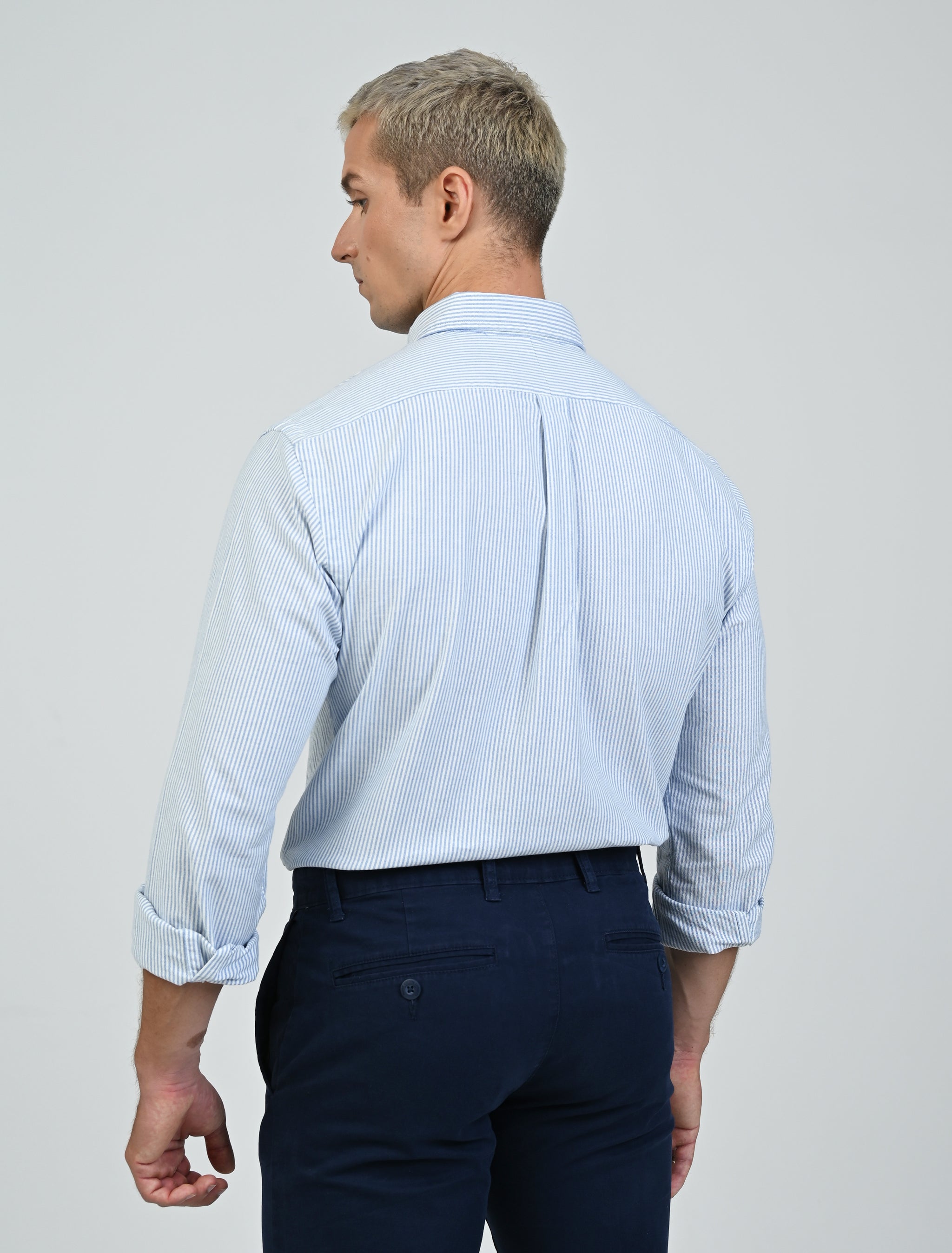 Model wearing the Marshall Menswear Marlowe Stripe premium Oxford button-down shirt featuring blue and white stripes, a tailored fit and refined smart casual styling.