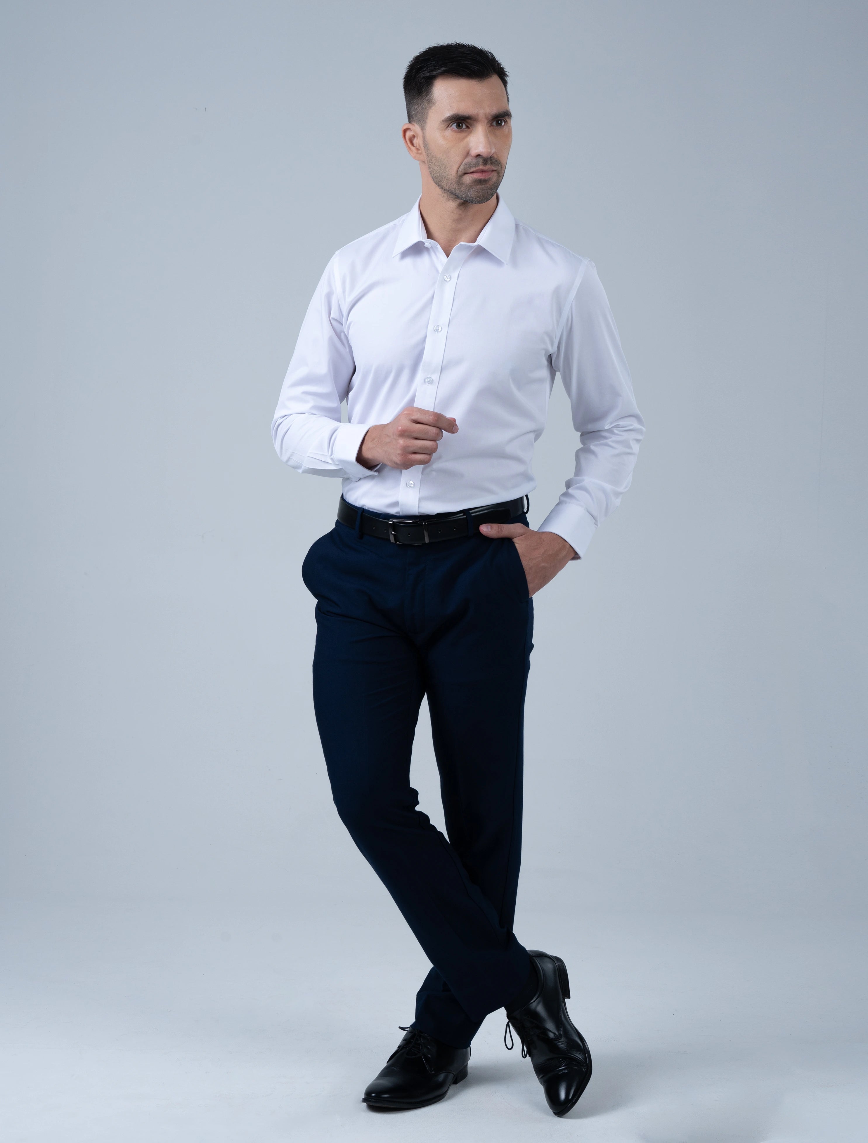 Full-length view of the Marshall Menswear Cambridge white men's cotton dress shirt paired with navy trousers and black leather shoes for modern office wear.