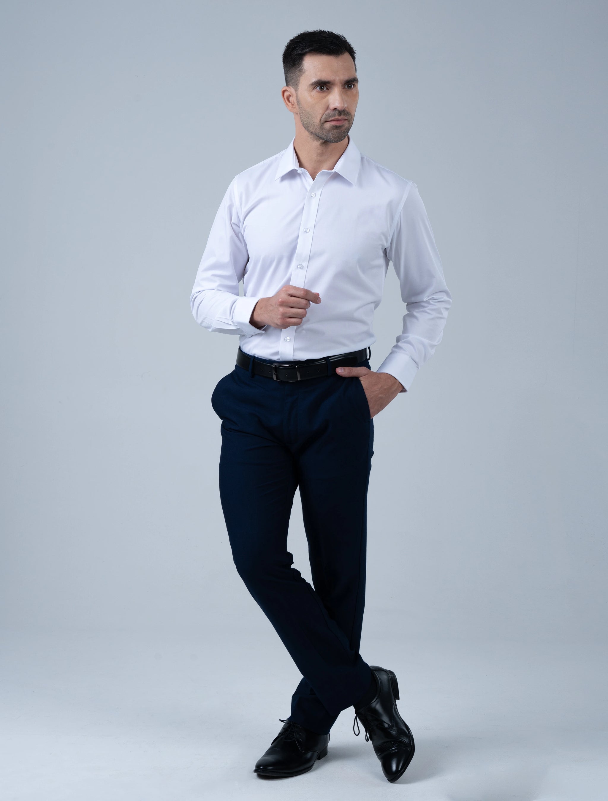 Full-length view of the Marshall Menswear Cambridge white men's cotton dress shirt paired with navy trousers and black leather shoes for modern office wear.
