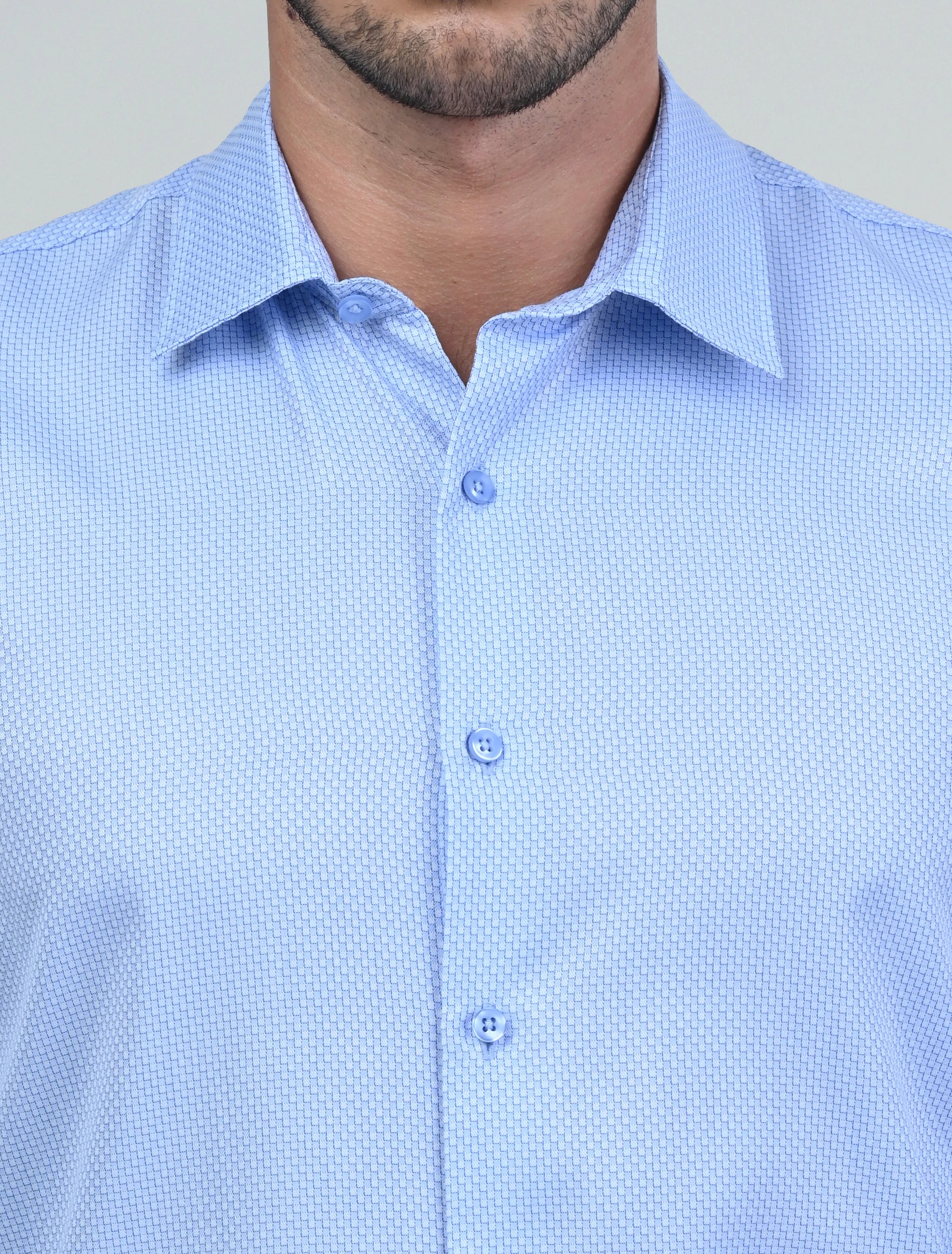 Close-up of the Marshall Menswear Montague Light Blue men's dress shirt highlighting the refined textured fabric, premium buttons and structured spread collar for a polished finish.