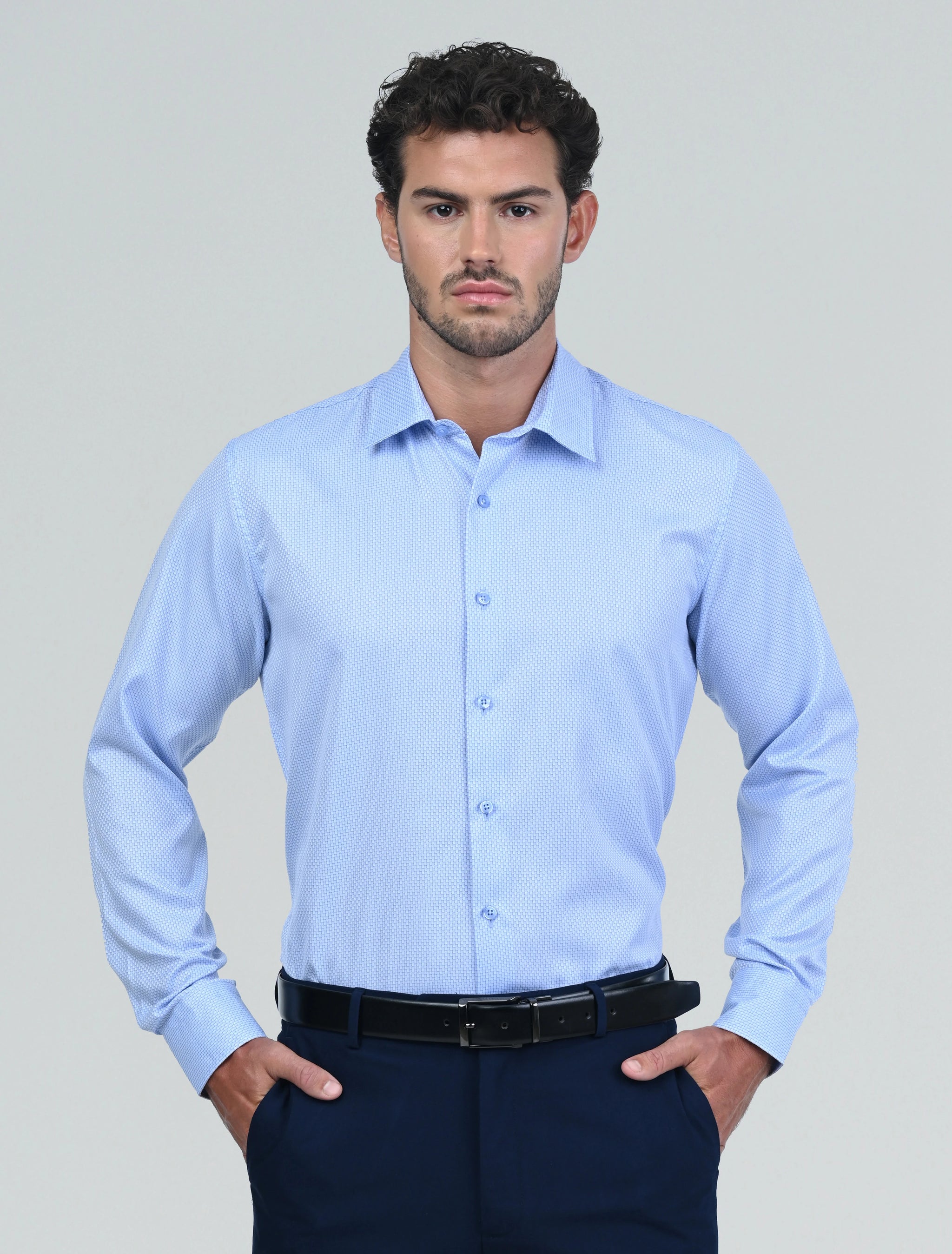 Model wearing the Marshall Menswear Montague Light Blue men's textured dress shirt styled with navy tailored trousers for a refined smart casual look that transitions effortlessly from office to evening.