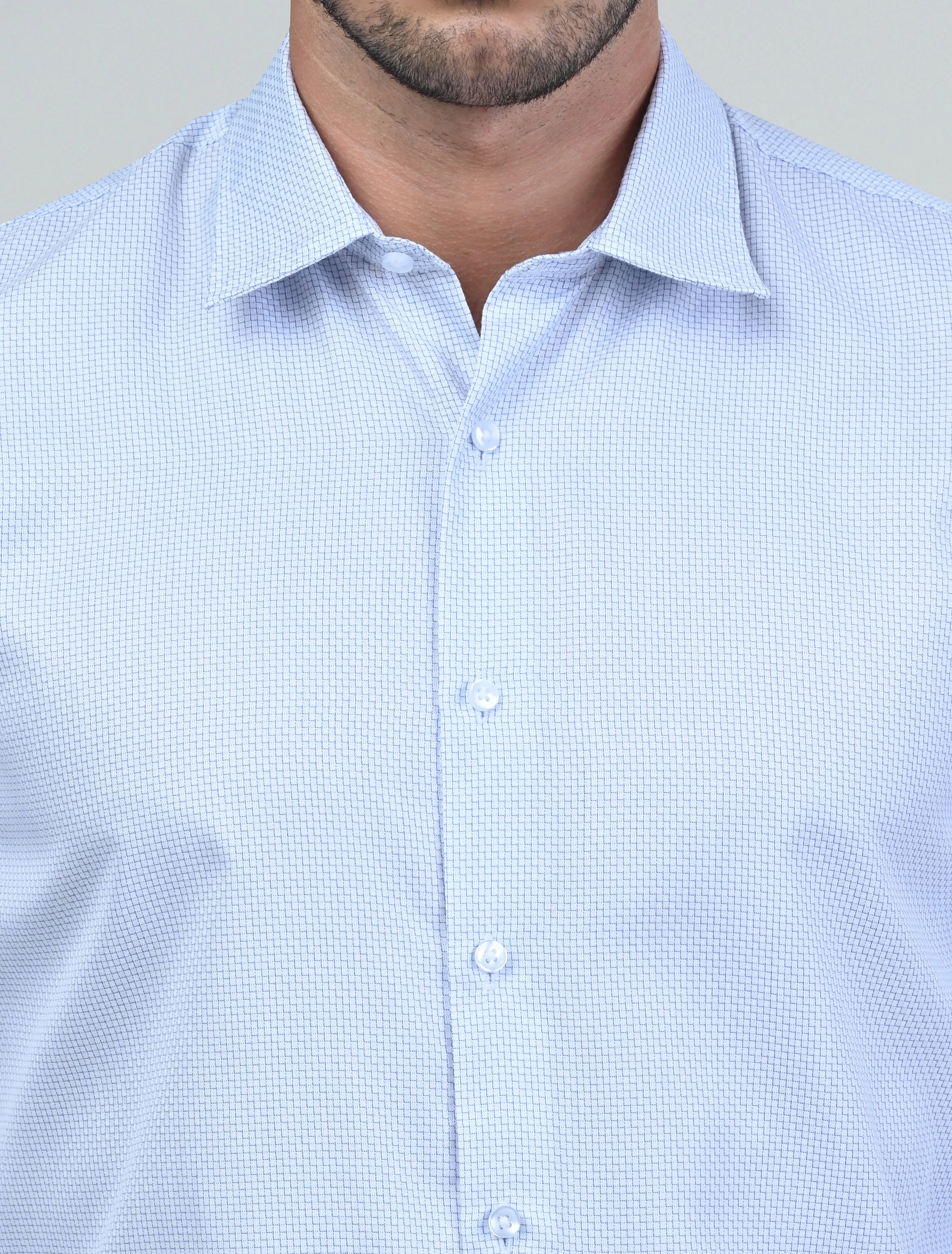 Close-up of the Marshall Menswear Montague White men's dress shirt highlighting the refined textured fabric, premium buttons and structured spread collar for a polished finish.