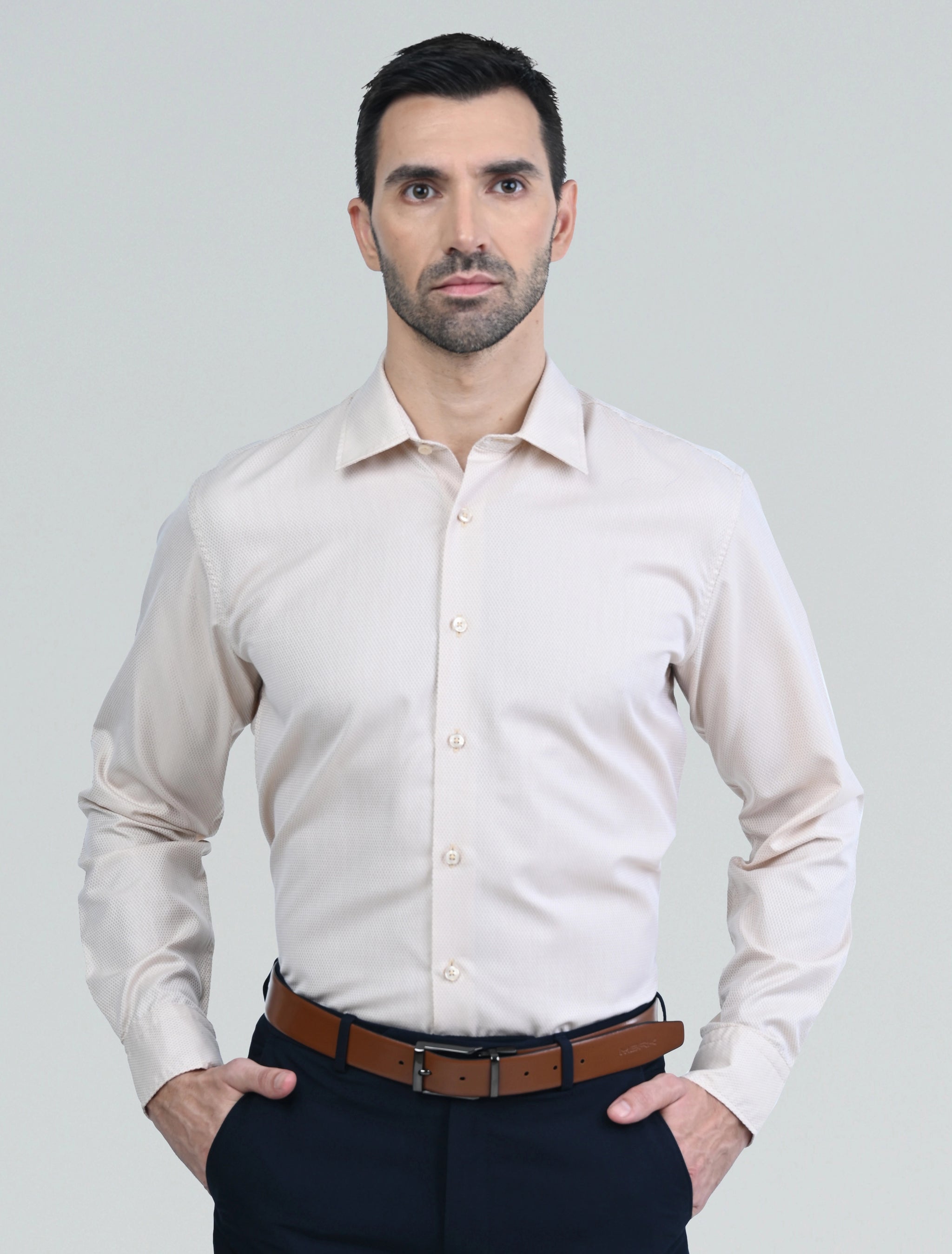 Marshall Menswear men's beige casual shirt with a tailored fit, classic collar, and long sleeves, styled with navy chinos for a smart casual everyday look.
