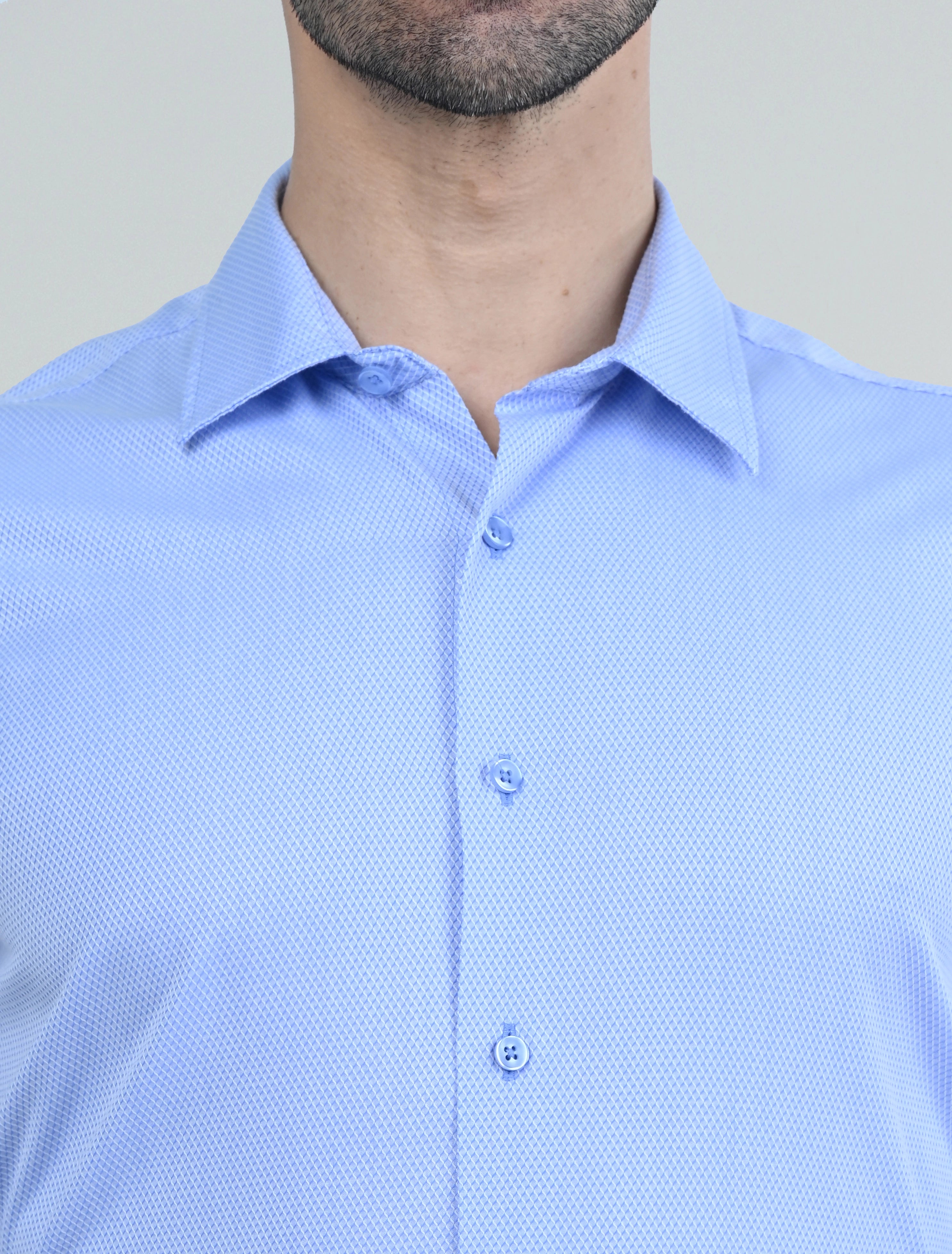 Close-up of the Marshall Menswear men's blue casual shirt showcasing the subtle textured fabric, classic collar, button-front placket, and refined tailored finish.