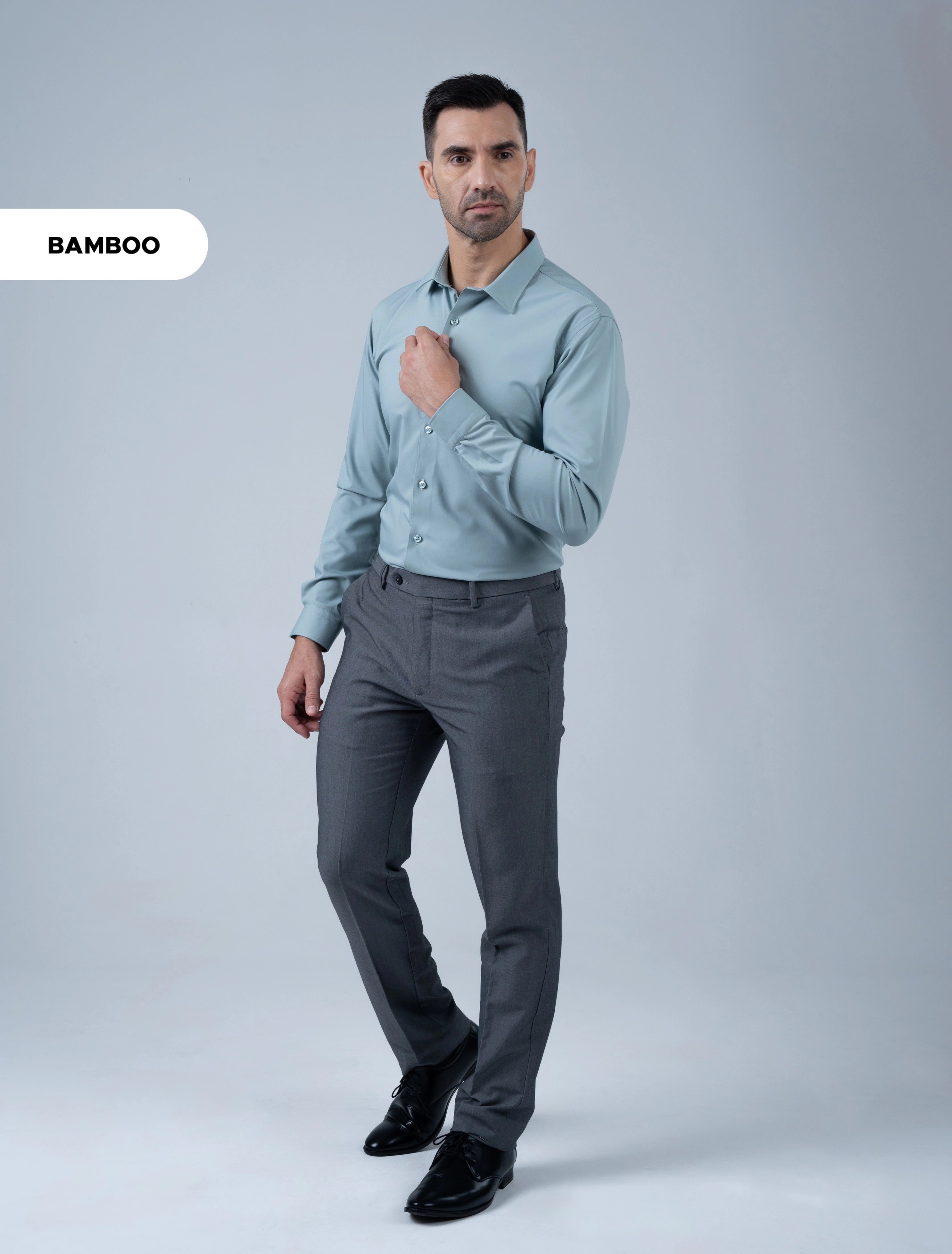 Marshall Menswear Bromley sage green bamboo business shirt for men styled with grey trousers and dress shoes for professional office wear.