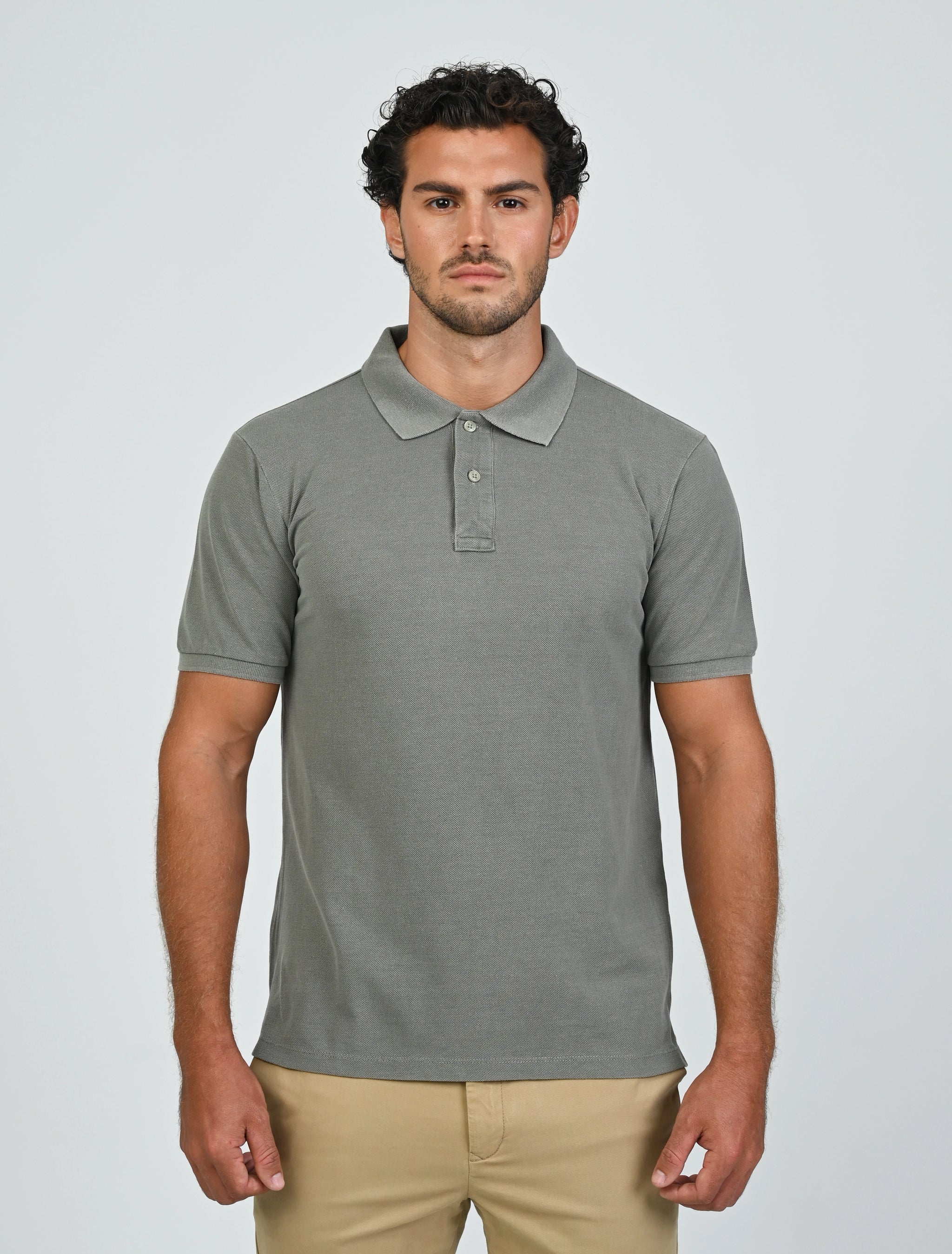 Model wearing the Marshall Menswear Atelier Smoke men's polo shirt with beige chinos for a refined smart casual outfit.