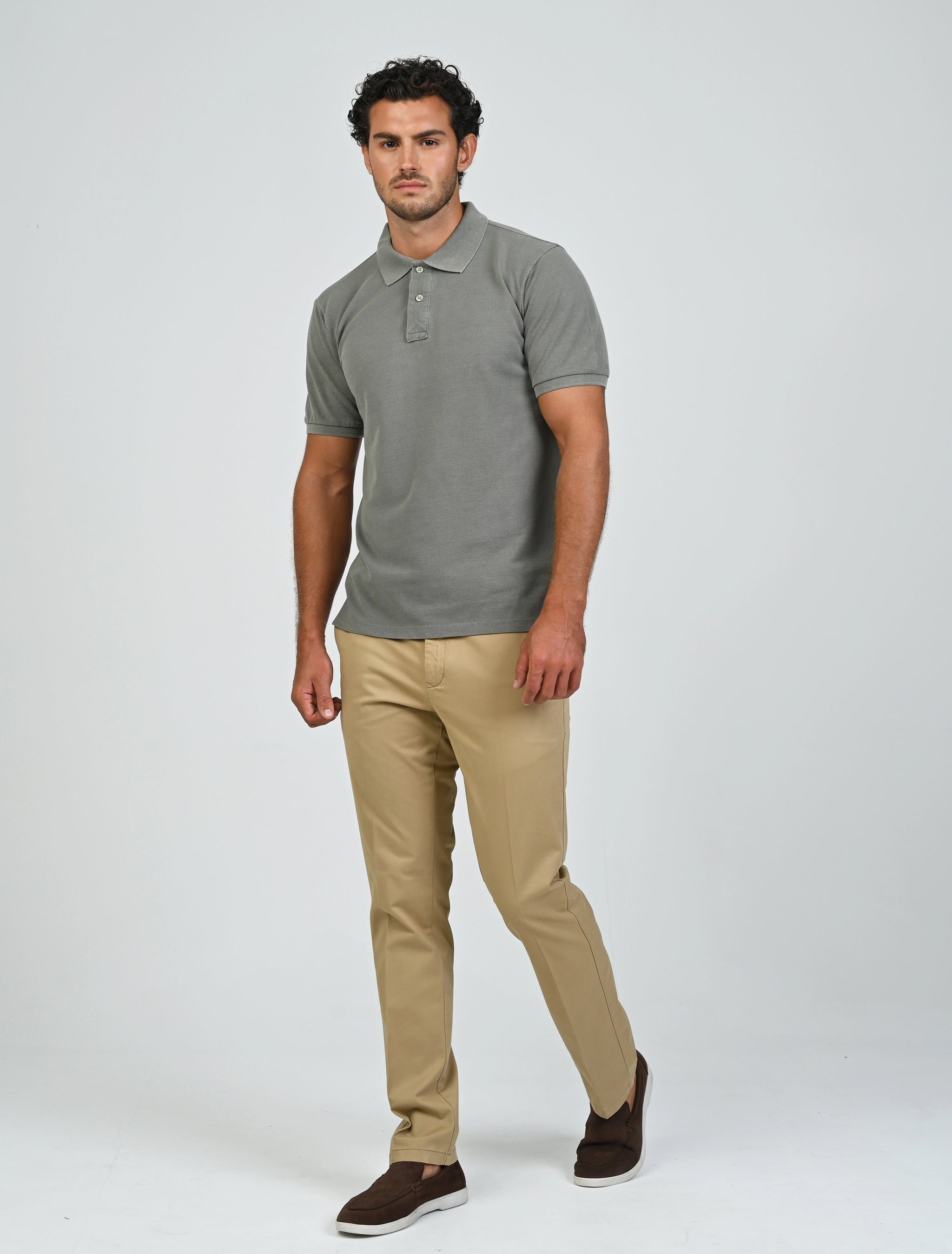 Full-length view of a model wearing the Marshall Menswear Atelier Smoke men's polo shirt with beige chinos for a professional office and smart casual outfit.