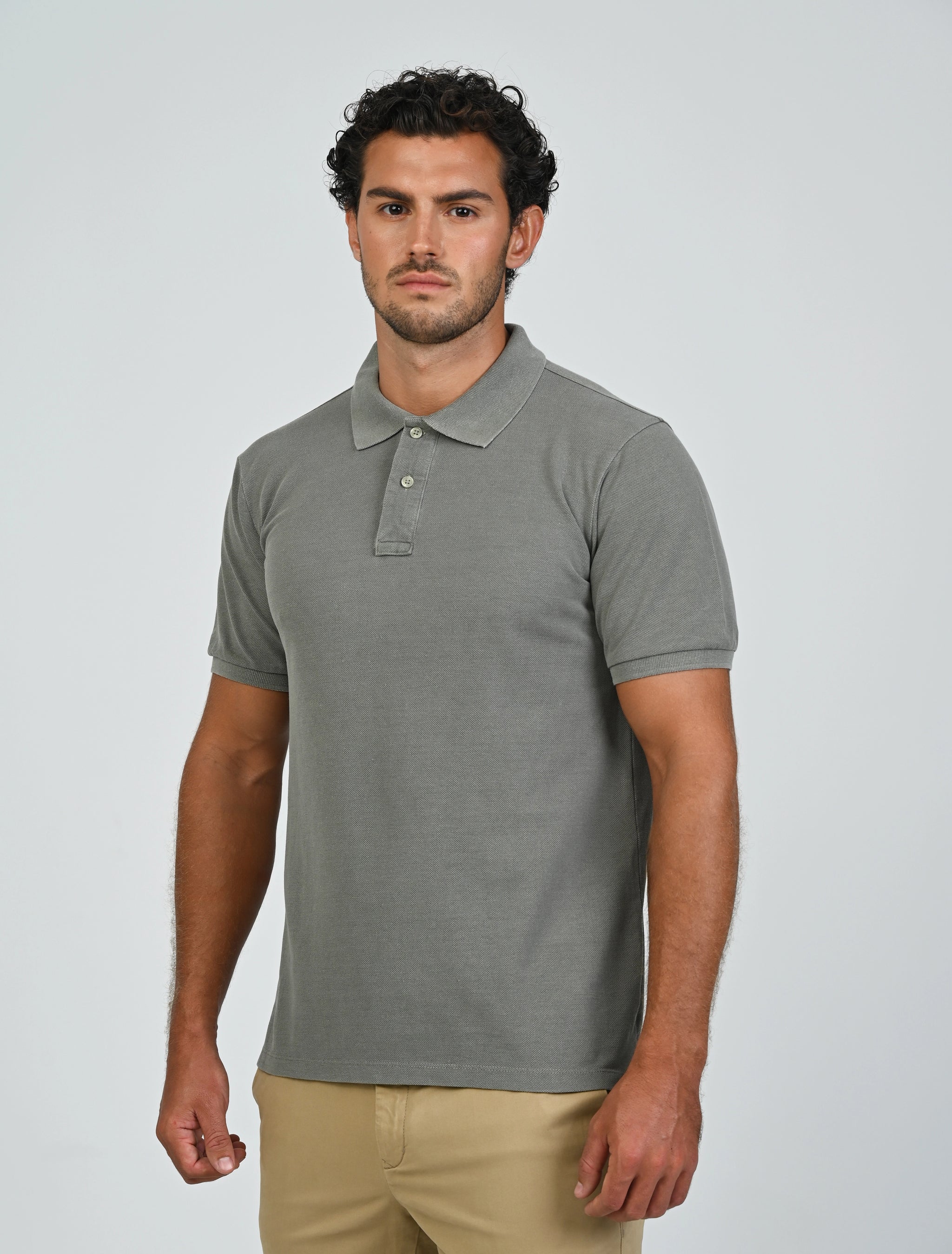 Three-quarter view of the Marshall Menswear Atelier Smoke men's polo shirt styled with beige chinos for a modern business casual look.