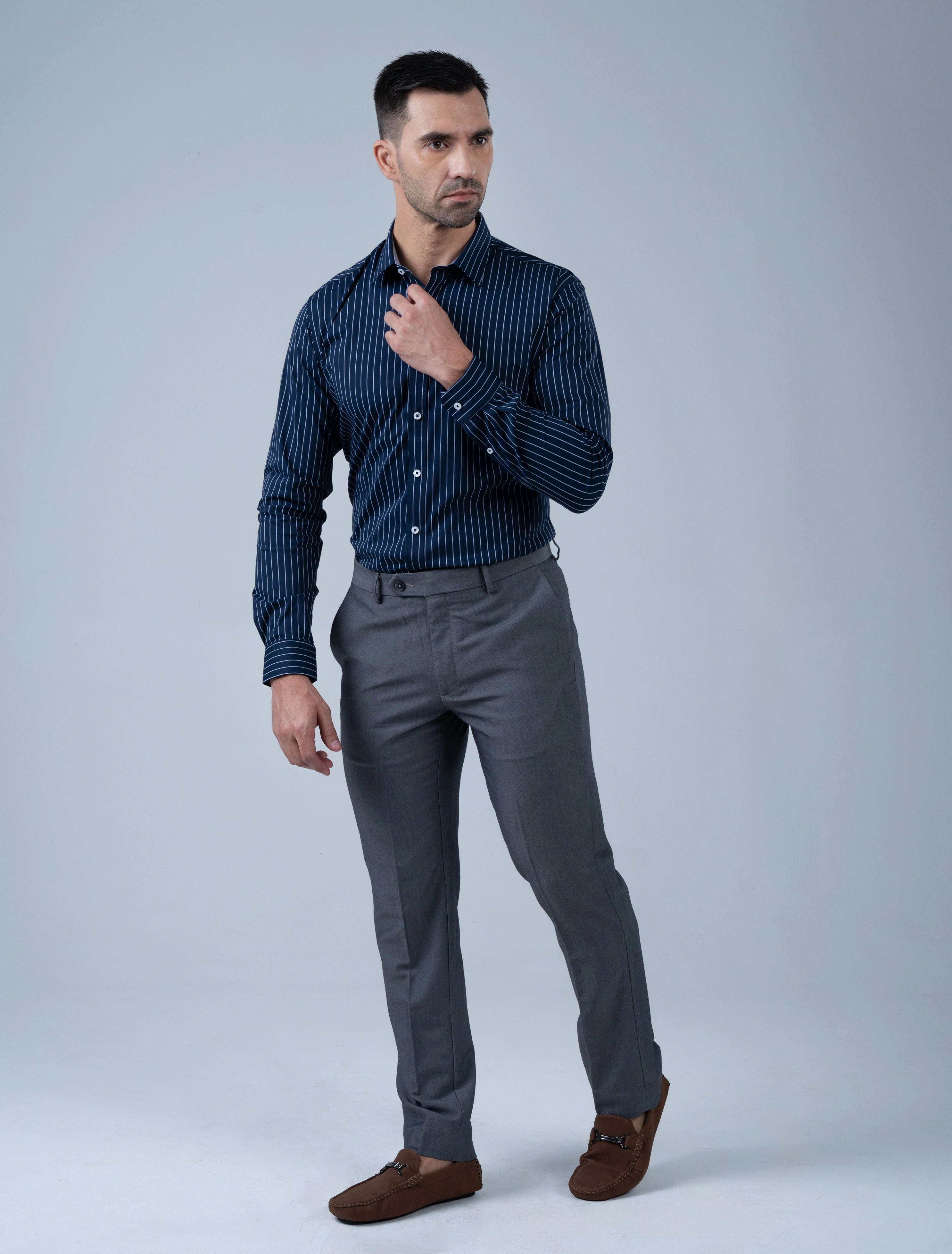 Marshall Menswear Kingsley men's navy stripe shirt styled with tailored grey trousers and loafers for a sophisticated smart casual outfit.