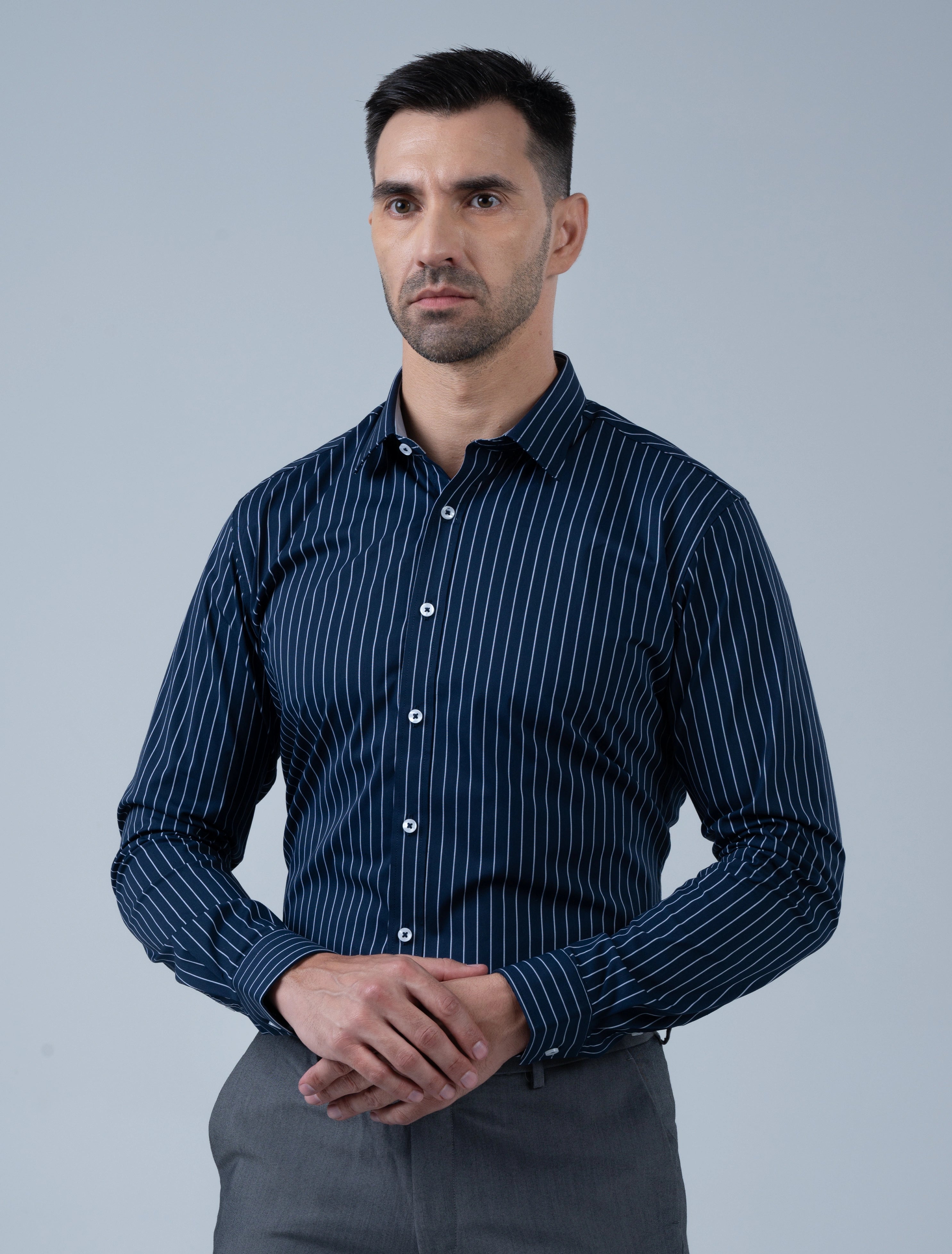 Men's navy blue striped smart casual shirt by Marshall Menswear, styled with grey trousers for a sharp modern look ideal for dinners and evenings out