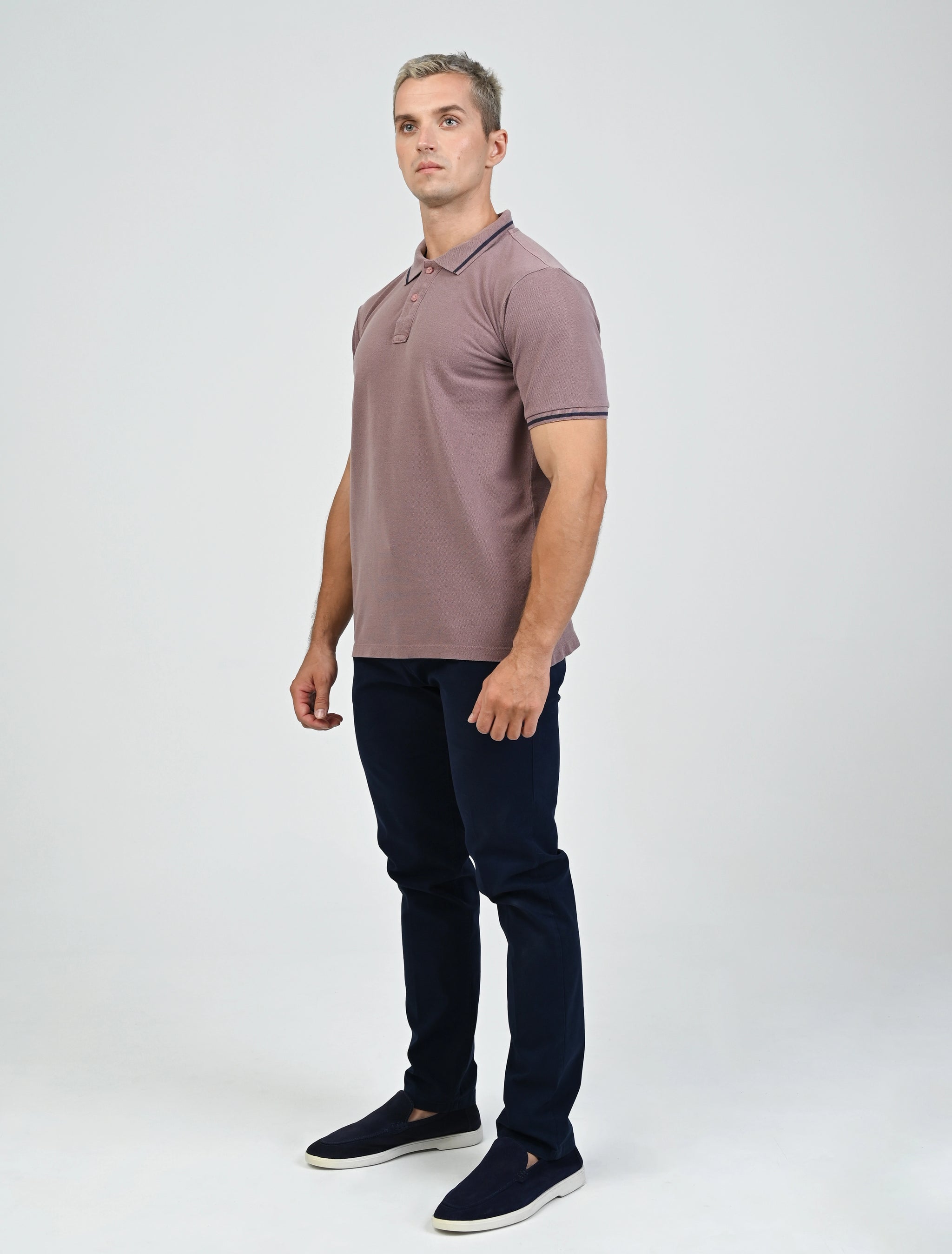 Full-length view of a model wearing the Marshall Menswear Sterling Mocha men's polo shirt with contrast blue tipping, navy chinos  for an elevated smart casual outfit.
