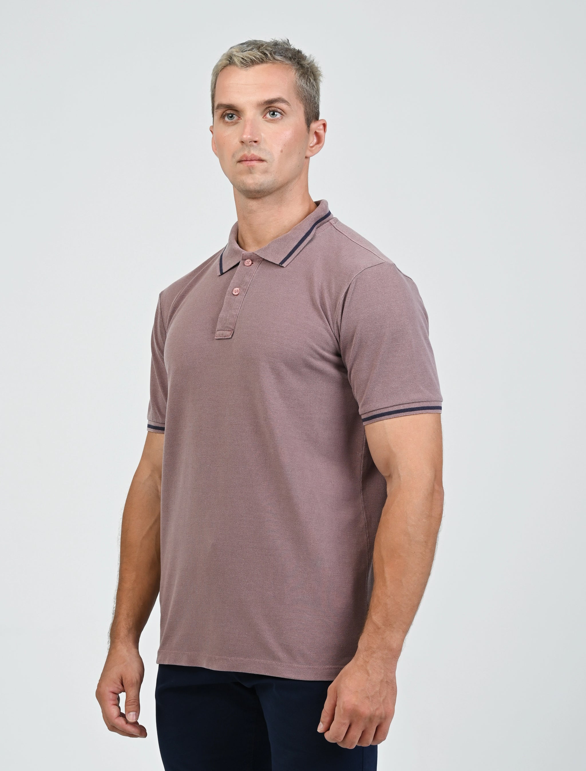 Three-quarter view of the Marshall Menswear Sterling Mocha men's polo shirt showcasing breathable pique fabric, contrast blue tipping, short sleeves and a tailored silhouette.