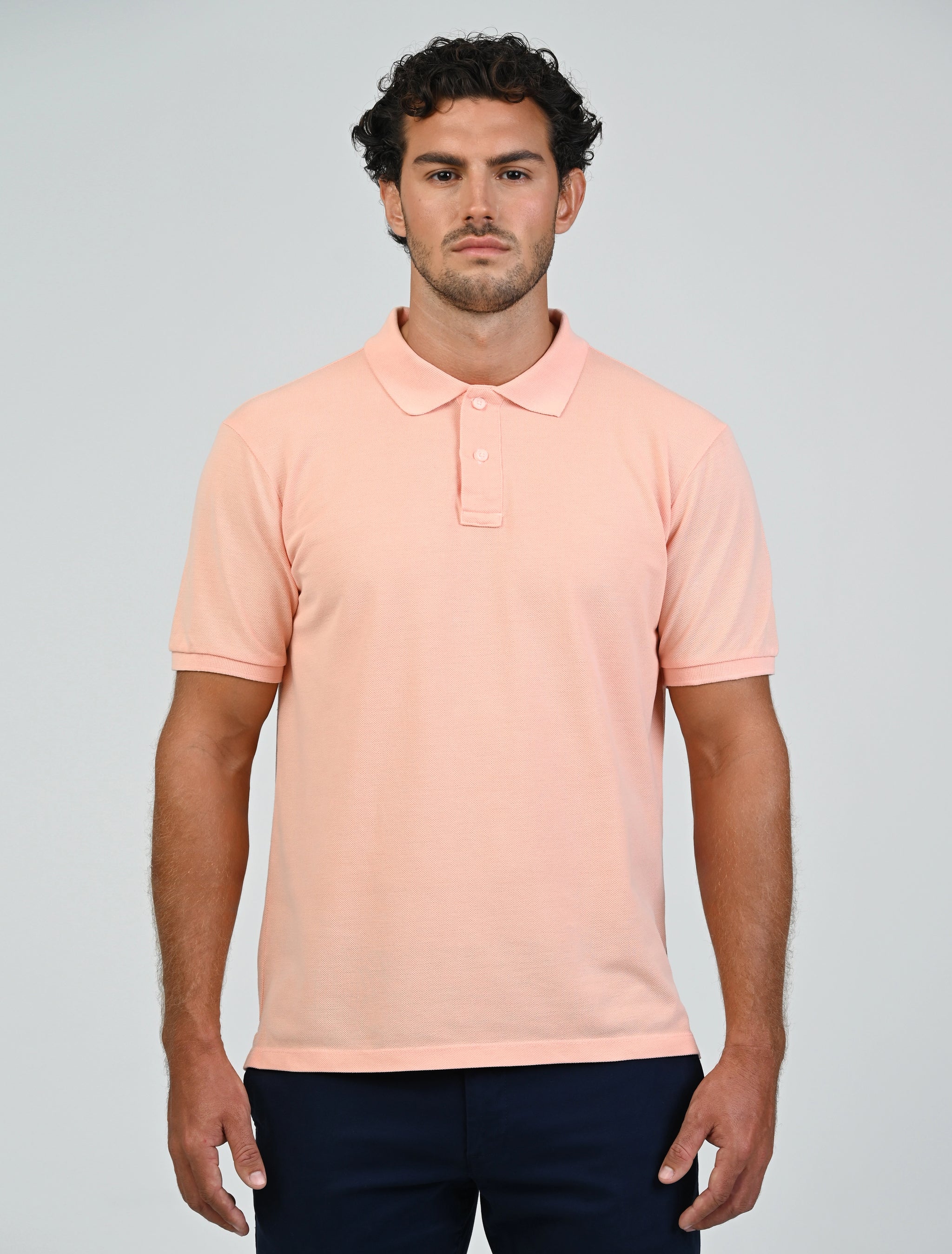 Marshall Menswear Atelier Apricot men's polo shirt styled with black tailored trousers for a smart business casual office and weekend outfit.