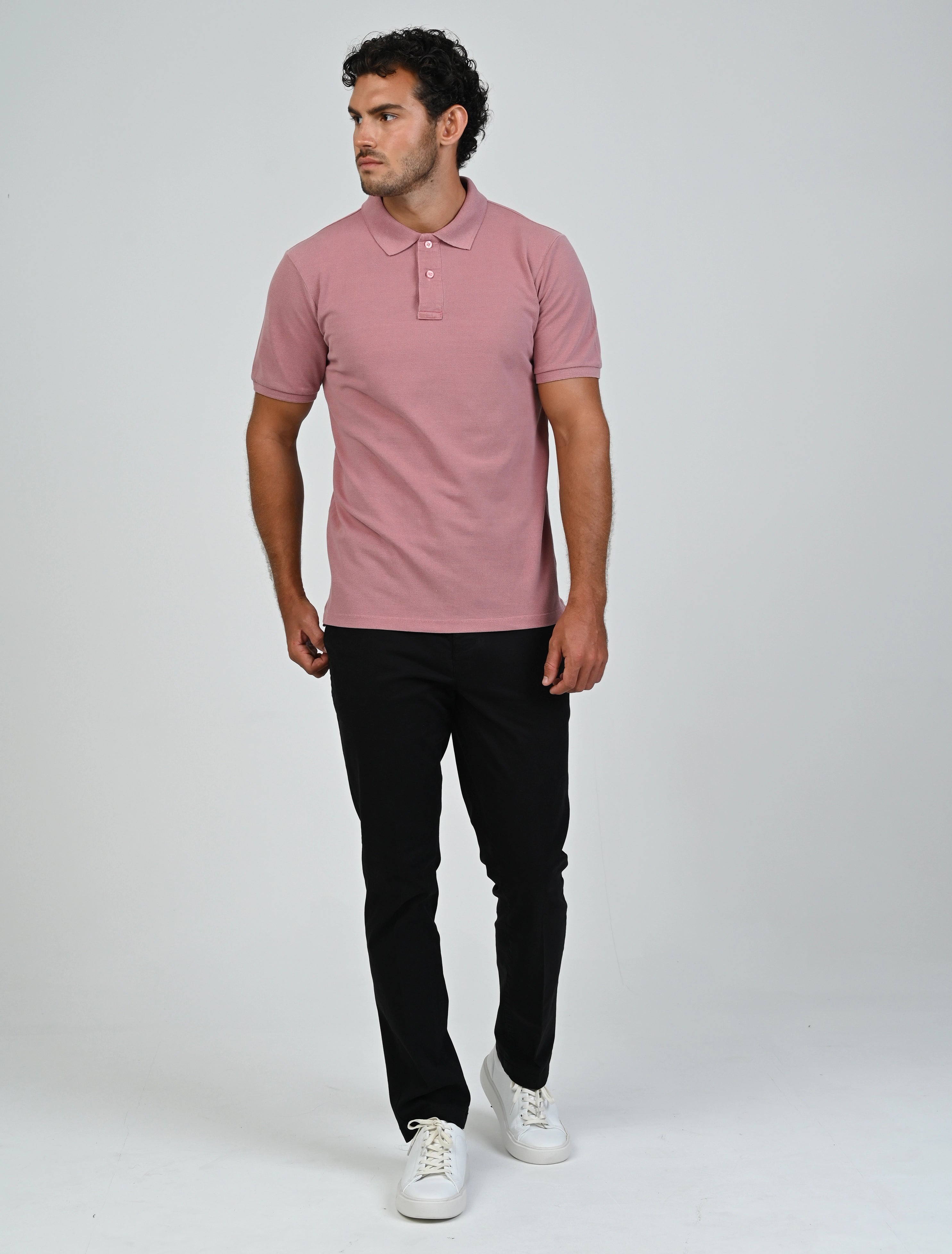 Model wearing the Marshall Menswear Atelier Salmon Pink men's polo shirt with black tailored trousers for a smart business casual office look.